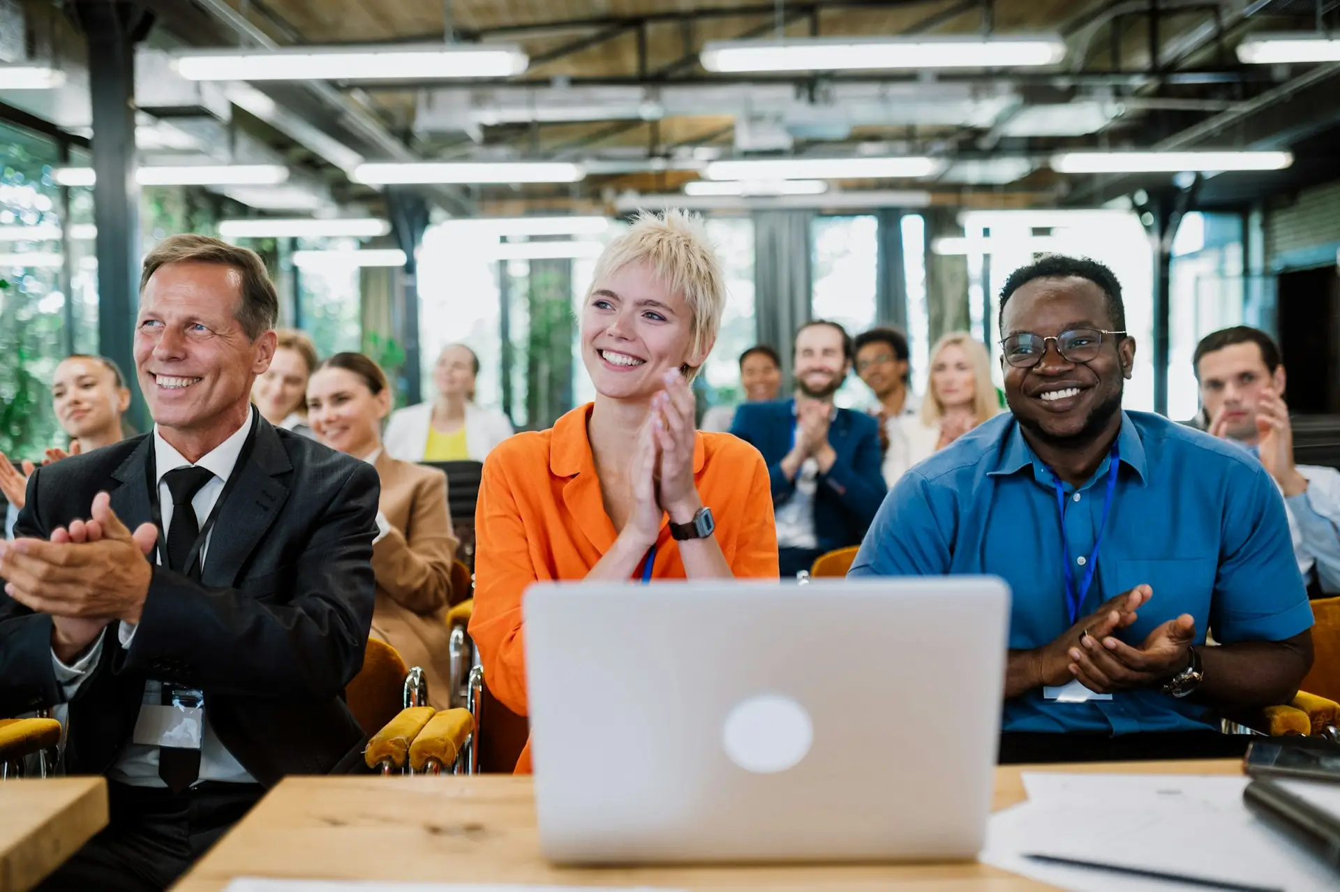 Enthusiastic professionals applauding during a corporate training session